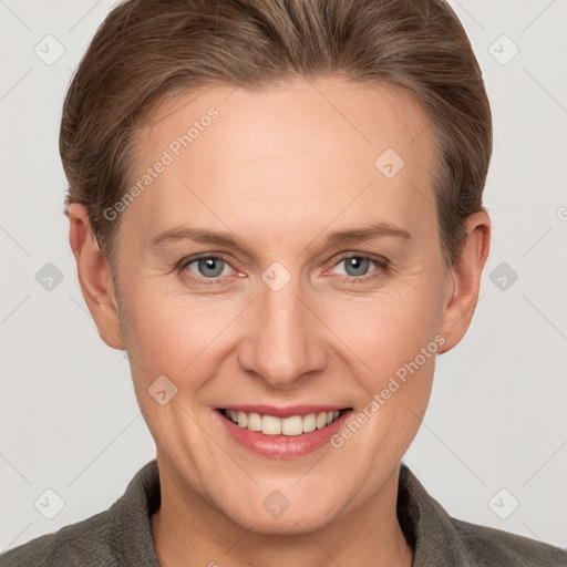 Joyful white adult female with short  brown hair and grey eyes