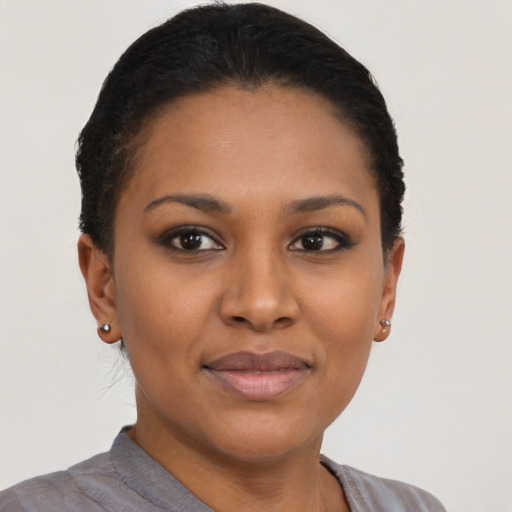 Joyful black young-adult female with short  brown hair and brown eyes