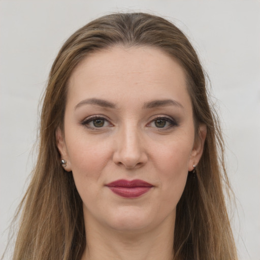 Joyful white young-adult female with long  brown hair and grey eyes