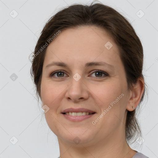 Joyful white adult female with medium  brown hair and grey eyes