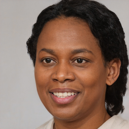 Joyful black young-adult female with medium  black hair and brown eyes