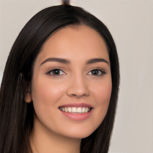 Joyful white young-adult female with long  black hair and brown eyes