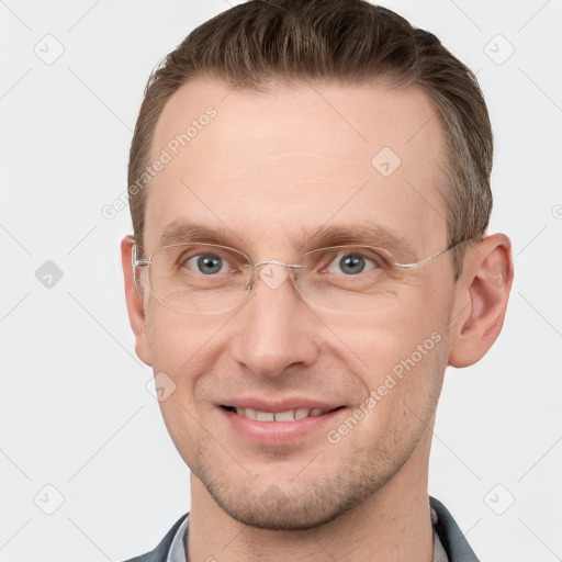 Joyful white adult male with short  brown hair and grey eyes