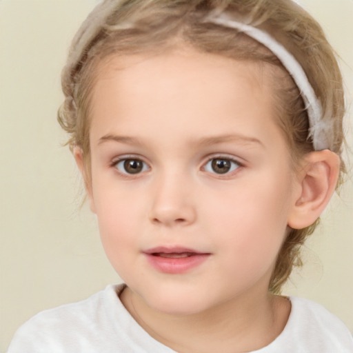 Joyful white child female with short  brown hair and brown eyes