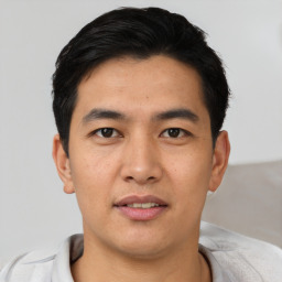 Joyful asian young-adult male with short  black hair and brown eyes