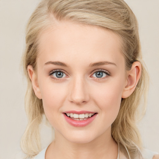 Joyful white young-adult female with medium  brown hair and blue eyes