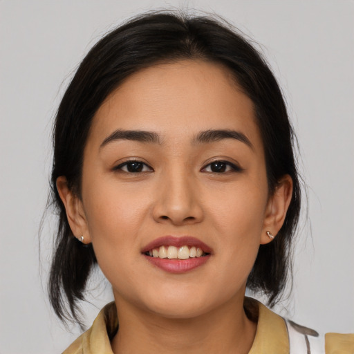 Joyful latino young-adult female with medium  brown hair and brown eyes