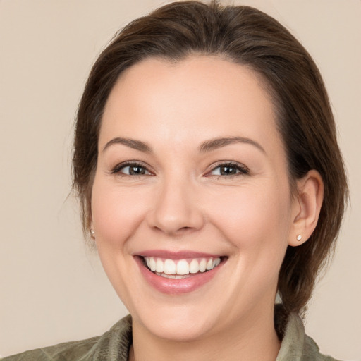 Joyful white young-adult female with medium  brown hair and brown eyes