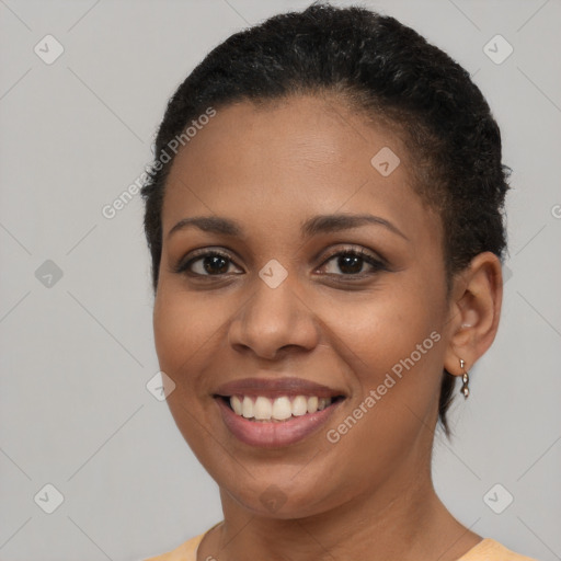 Joyful black young-adult female with short  brown hair and brown eyes