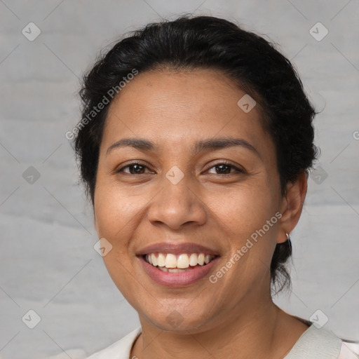 Joyful latino adult female with short  brown hair and brown eyes