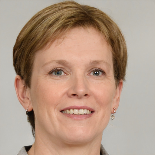 Joyful white adult female with medium  brown hair and grey eyes