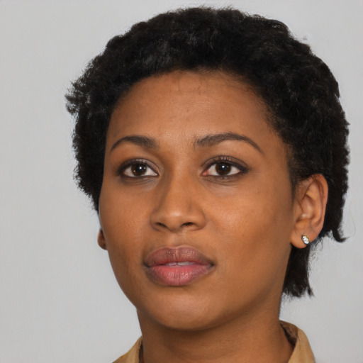 Joyful black young-adult female with short  black hair and brown eyes