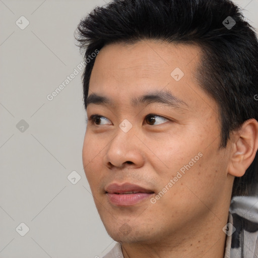 Joyful asian young-adult male with short  black hair and brown eyes