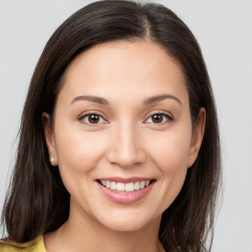 Joyful white young-adult female with medium  brown hair and brown eyes