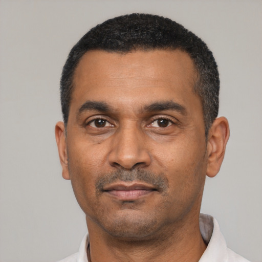 Neutral latino adult male with short  black hair and brown eyes