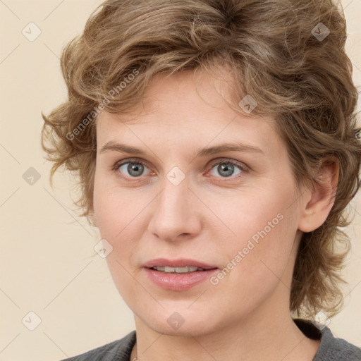 Joyful white young-adult female with medium  brown hair and blue eyes