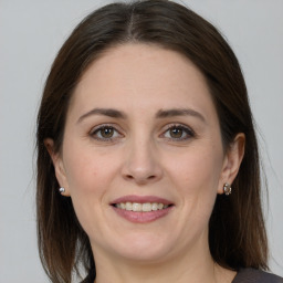 Joyful white young-adult female with medium  brown hair and grey eyes