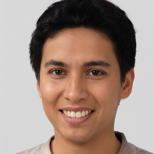 Joyful latino young-adult male with short  brown hair and brown eyes