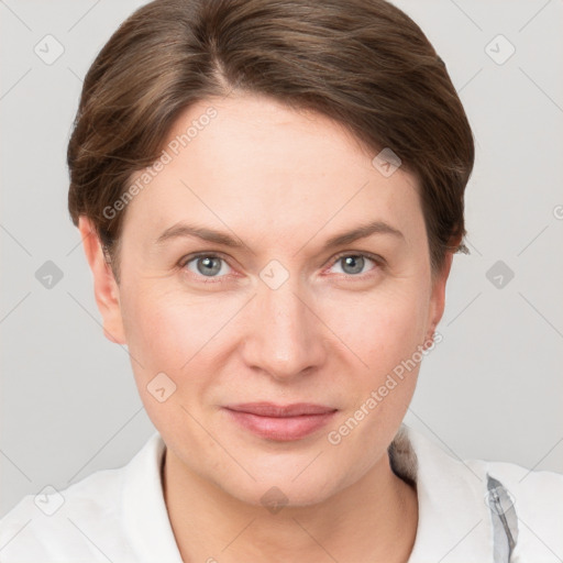 Joyful white young-adult female with short  brown hair and grey eyes