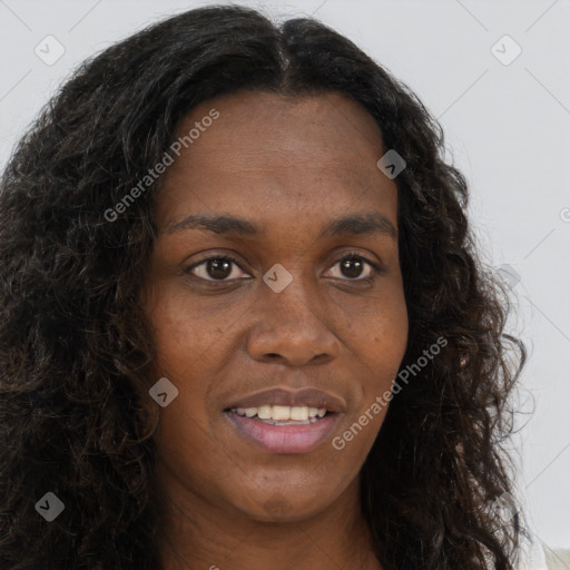 Joyful black young-adult female with long  brown hair and brown eyes