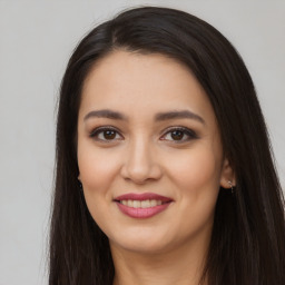 Joyful latino young-adult female with long  brown hair and brown eyes