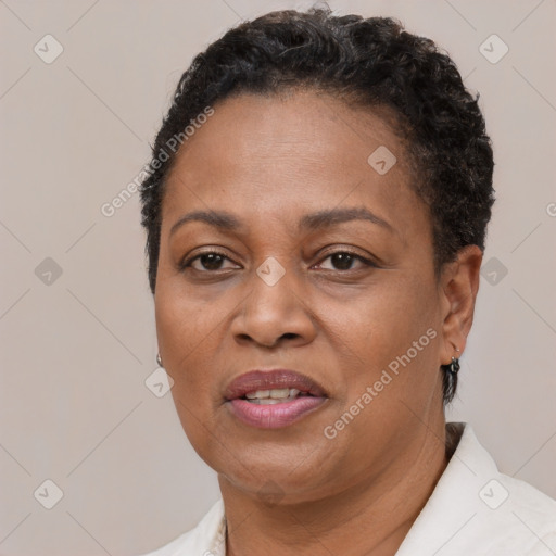 Joyful black adult female with short  brown hair and brown eyes