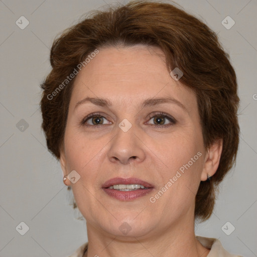 Joyful white adult female with medium  brown hair and green eyes