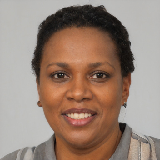Joyful black adult female with short  brown hair and brown eyes