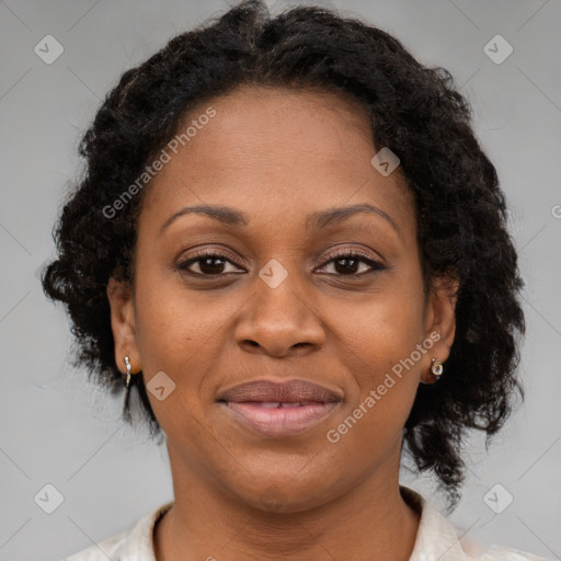 Joyful black adult female with medium  brown hair and brown eyes