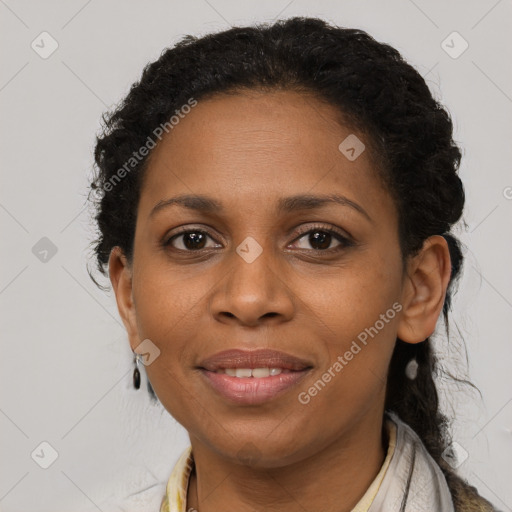 Joyful black young-adult female with long  brown hair and brown eyes