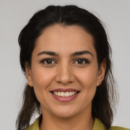 Joyful latino young-adult female with medium  brown hair and brown eyes