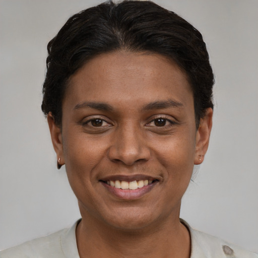 Joyful latino young-adult female with short  black hair and brown eyes