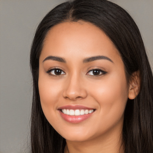 Joyful white young-adult female with long  black hair and brown eyes