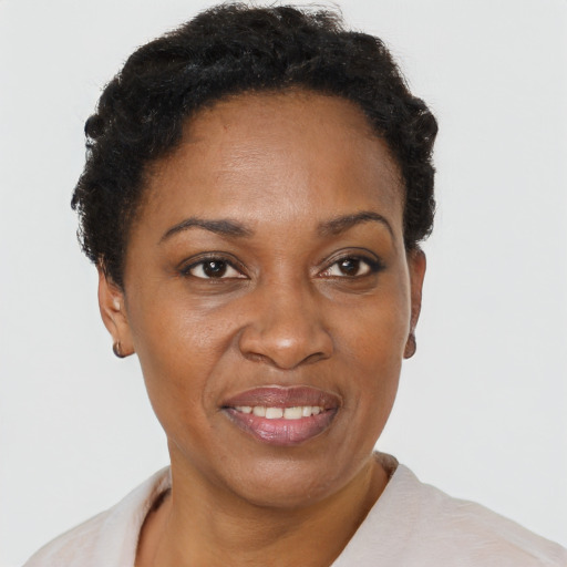 Joyful black adult female with short  brown hair and brown eyes