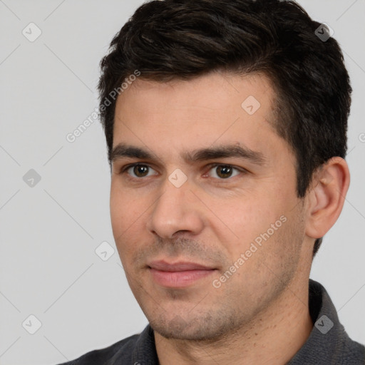 Joyful white young-adult male with short  black hair and brown eyes