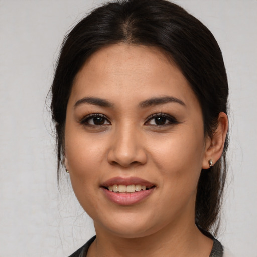 Joyful asian young-adult female with long  brown hair and brown eyes