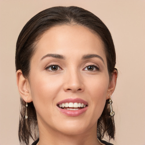 Joyful white young-adult female with long  brown hair and brown eyes