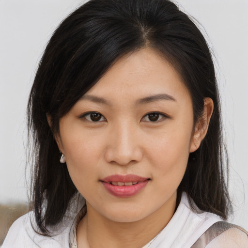Joyful asian young-adult female with medium  brown hair and brown eyes