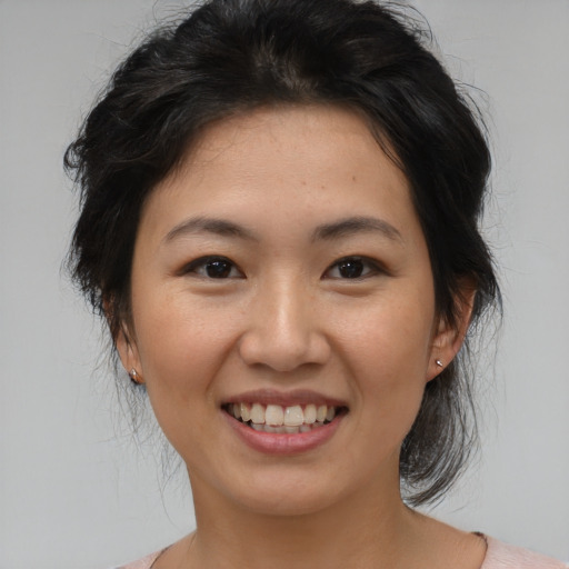 Joyful asian young-adult female with medium  brown hair and brown eyes