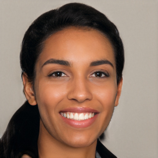 Joyful latino young-adult female with short  black hair and brown eyes