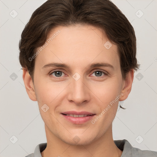 Joyful white young-adult female with short  brown hair and grey eyes