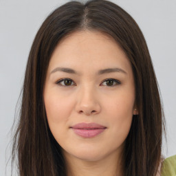 Joyful asian young-adult female with long  brown hair and brown eyes