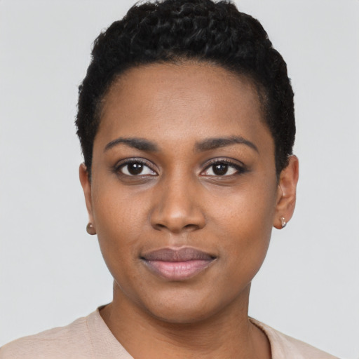 Joyful black young-adult female with short  black hair and brown eyes