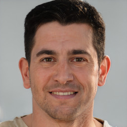 Joyful white adult male with short  brown hair and brown eyes