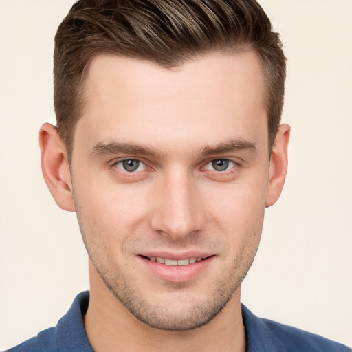 Joyful white young-adult male with short  brown hair and grey eyes