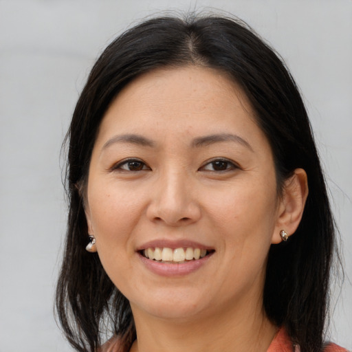 Joyful asian young-adult female with medium  brown hair and brown eyes