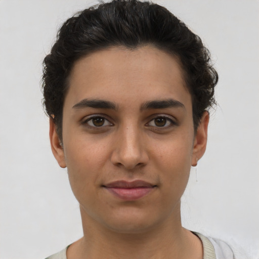 Joyful latino young-adult female with short  brown hair and brown eyes