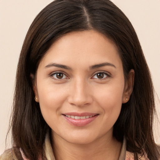 Joyful white young-adult female with long  brown hair and brown eyes