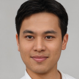 Joyful asian young-adult male with short  black hair and brown eyes