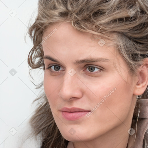 Joyful white young-adult female with long  brown hair and blue eyes